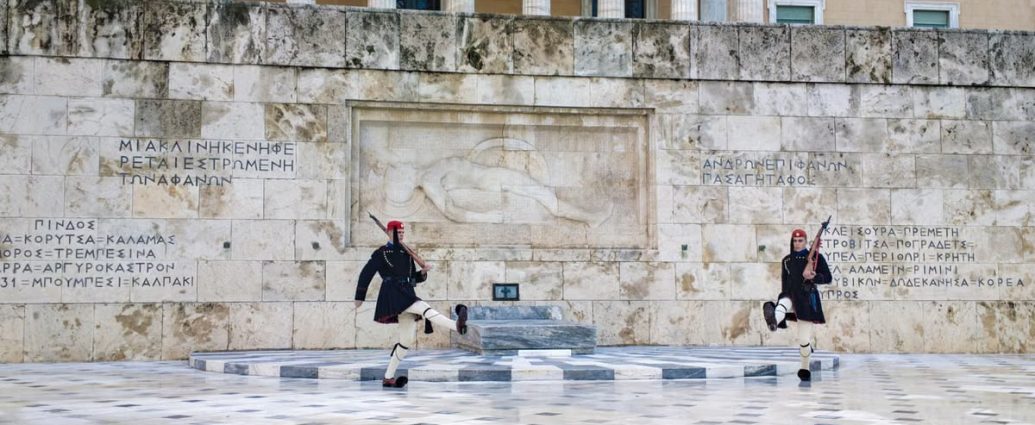 Traditional Evzone guards in ceremonial attire at the Tomb of the Unknown Soldier in Athens.