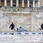 Traditional Evzone guards in ceremonial attire at the Tomb of the Unknown Soldier in Athens.